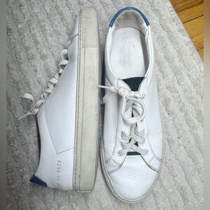 Common Projects Achilles Low in white leather with a blue heel tab.